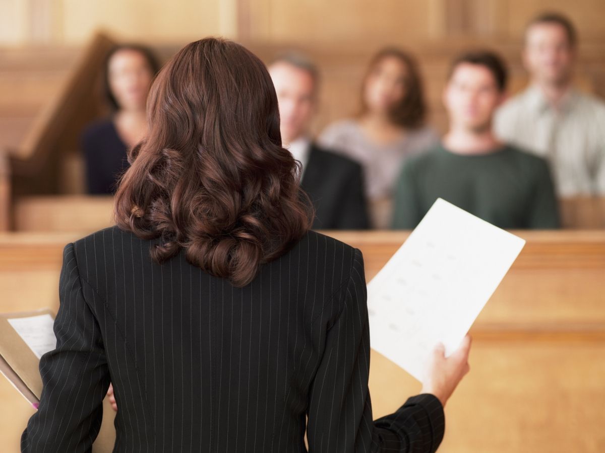 Female civil litigation lawyer addressing a jury in a courtroom.